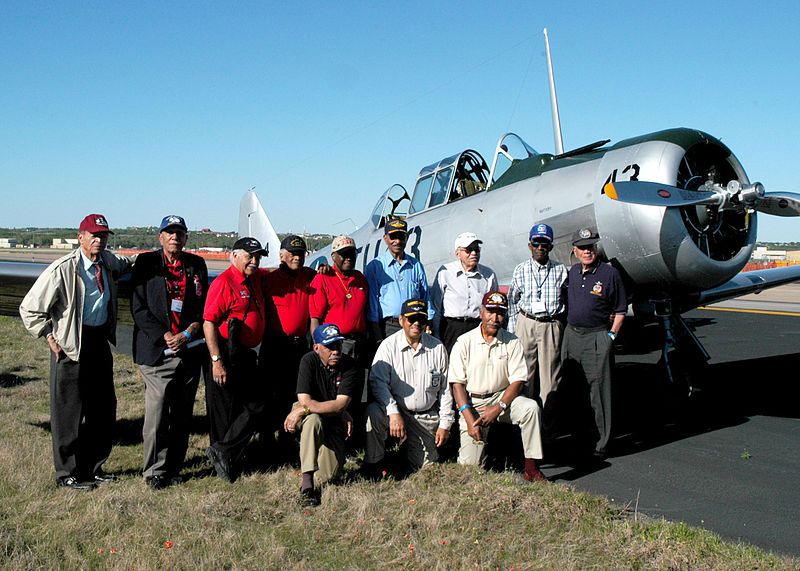 Several African American Tuskegee Airmen pose for a picture.