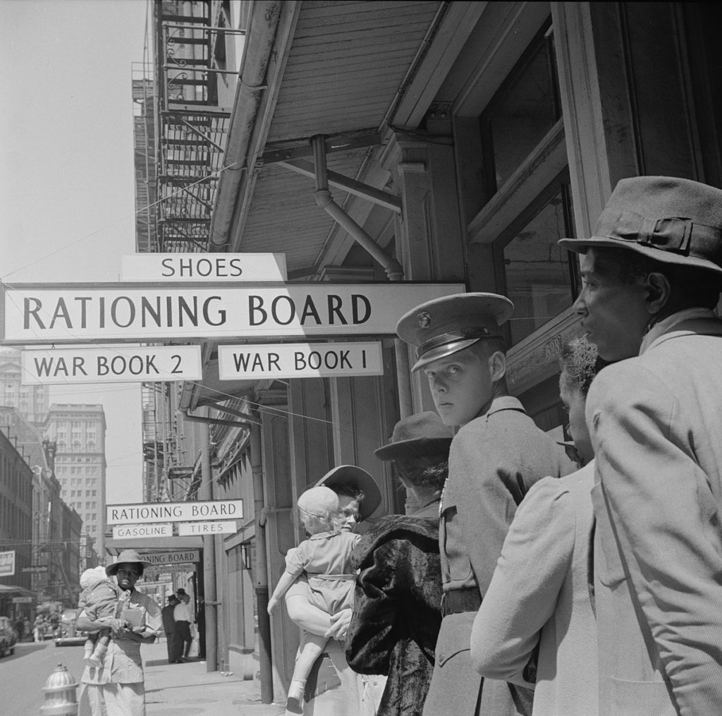 A line builds at a rationing board during World War II.